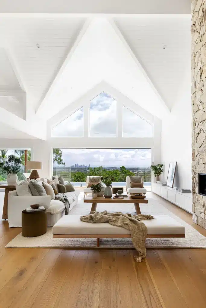 Freshly cleaned by Professional House Cleaners modern living room with high vaulted ceilings and natural light in a stylish Australian home.
