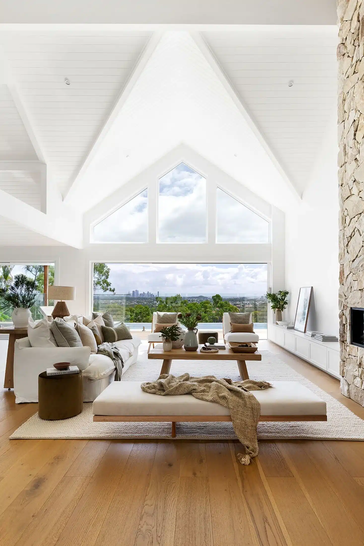 Freshly cleaned by Professional House Cleaners modern living room with high vaulted ceilings and natural light in a stylish Australian home.